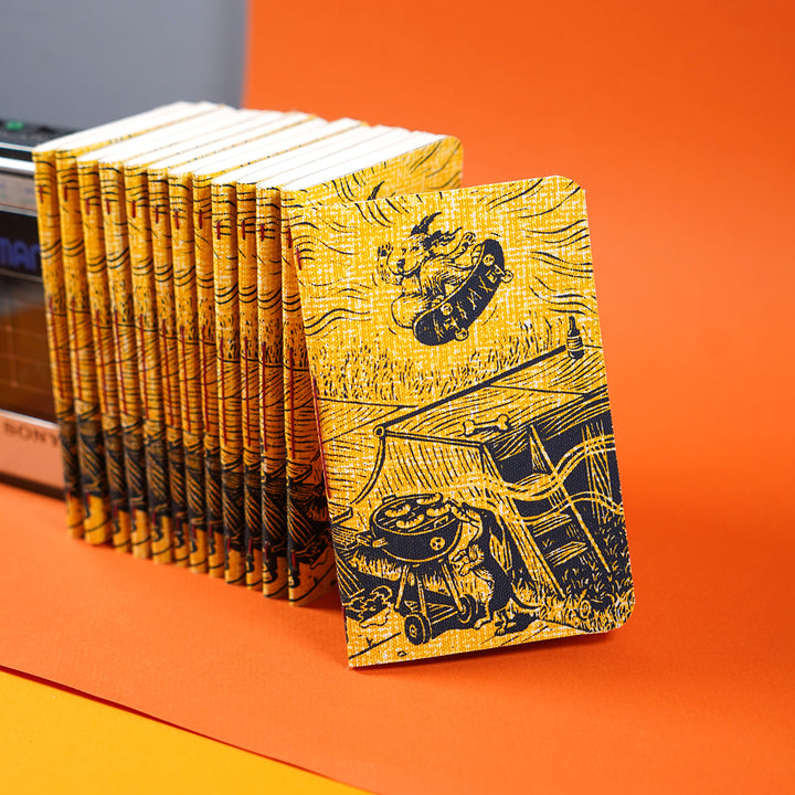 many notebooks standing together featuring dylan goldberger's dog gone summer journal design