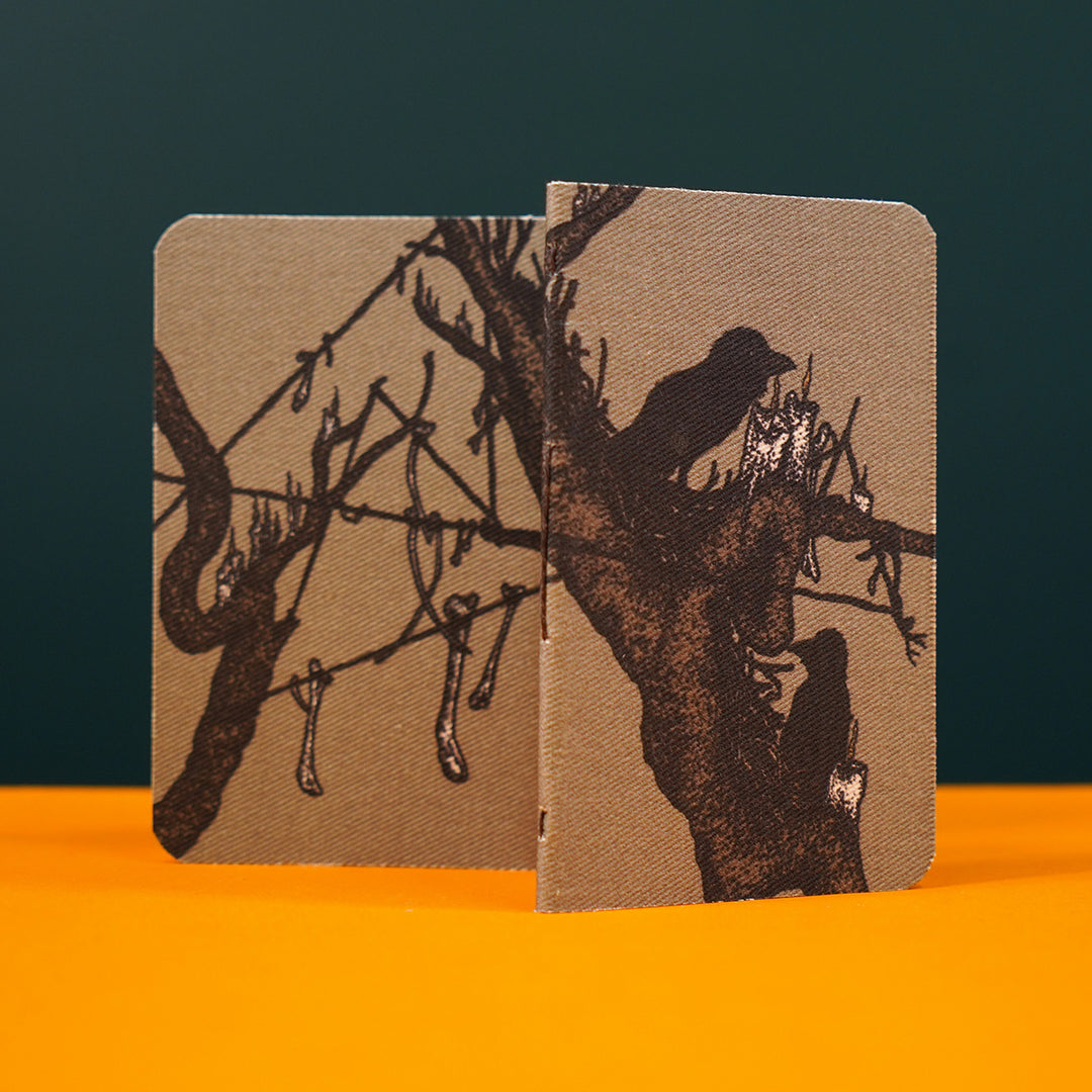 a journal design is shown standing on an orange tabletop. two notebooks are displayed at a slight angle, so that both the front and back covers show