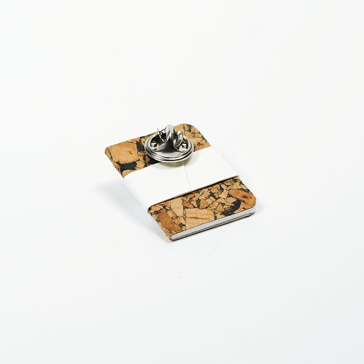 pin butterfly clasp on tiny notebook