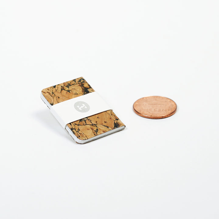 size comparison of mini notebook pin and a u.s. penny