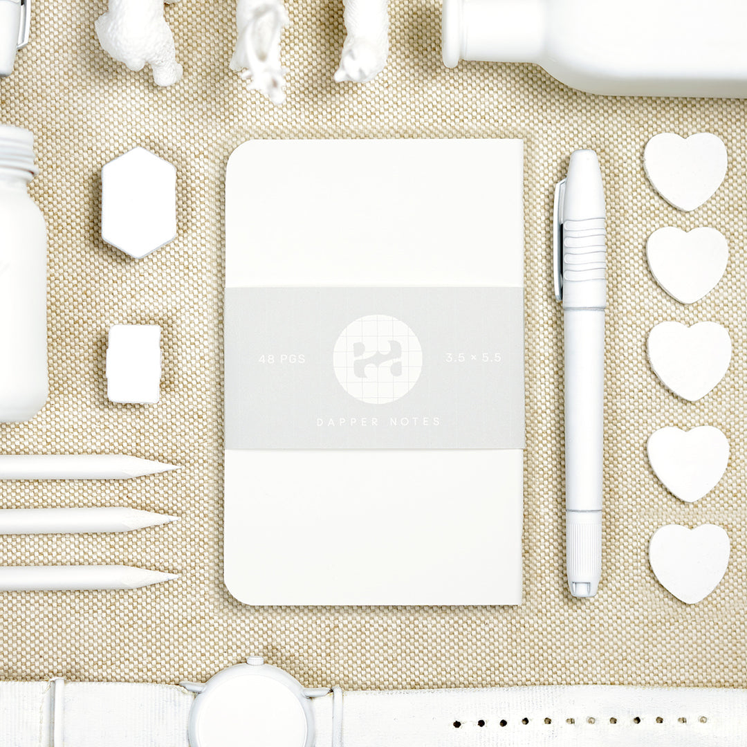 white pocket notebook with white object knolling