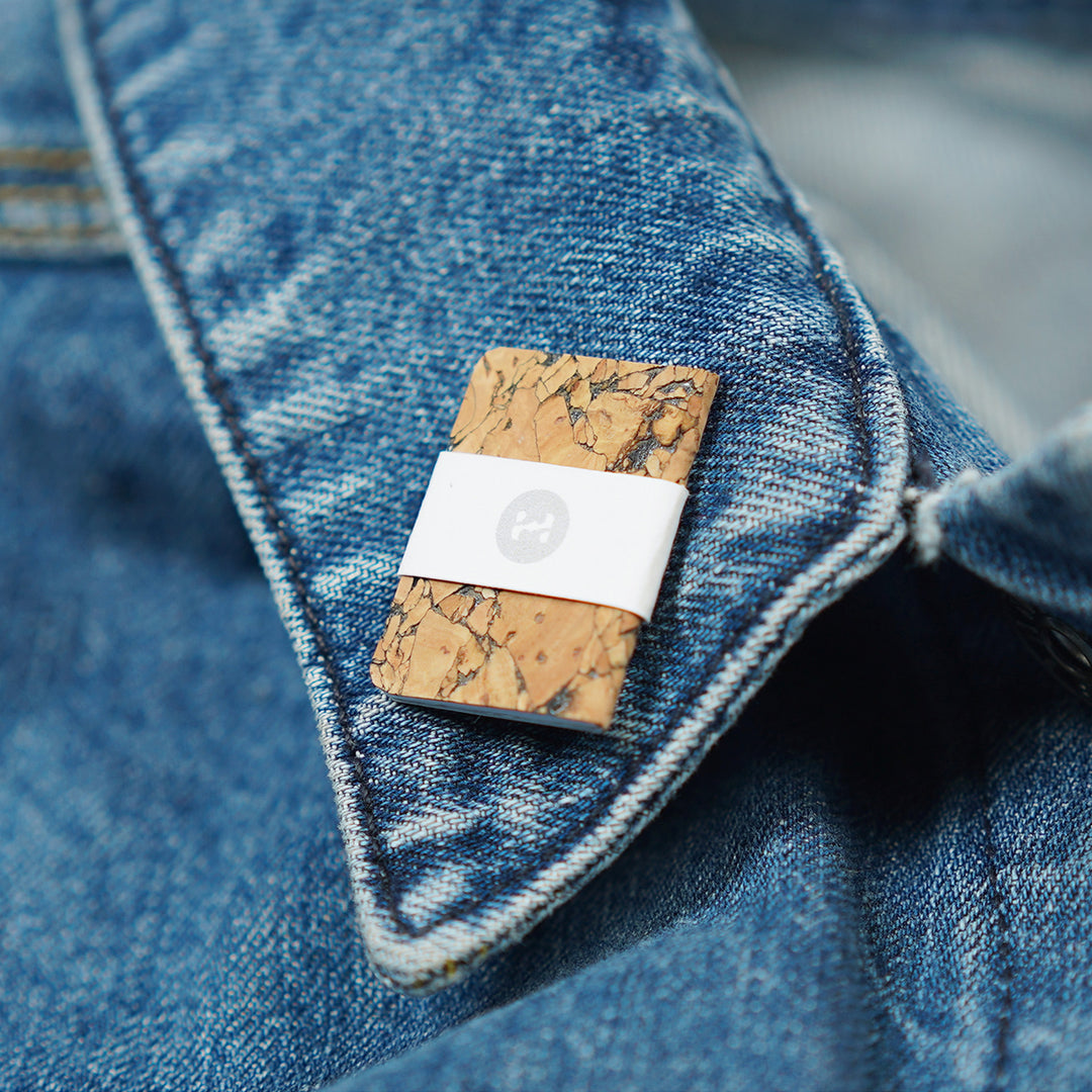 miniature cork notebook on jean jacket collar